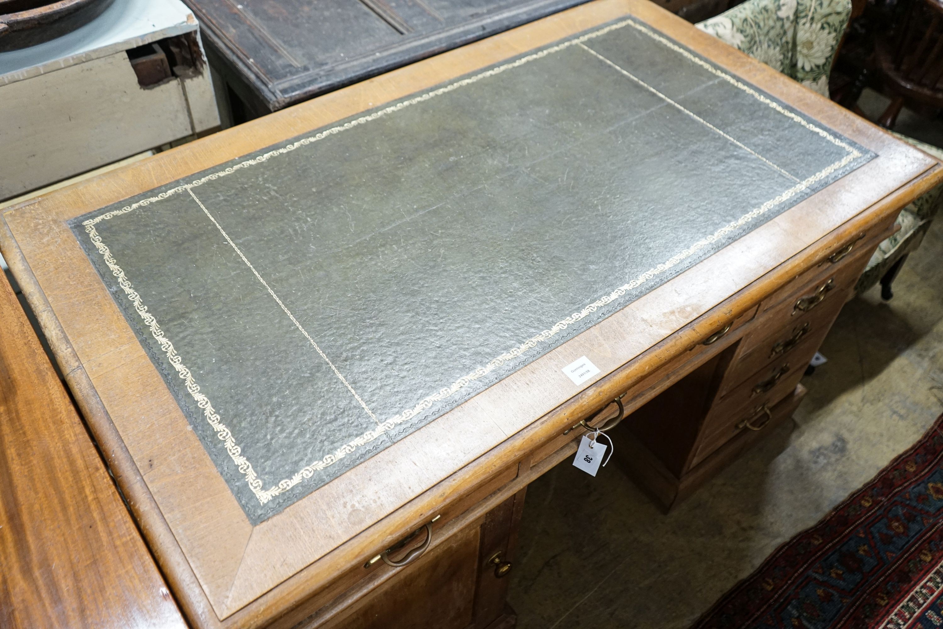 An Edwardian stripped beech pedestal desk, fitted eleven drawers, width 138cm, depth 80cm, height 76cm